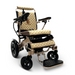 The ComfyGo MAJESTIC IQ-8000 is a luxurious gold-colored electric wheelchair featuring quilted upholstery and black accents. It includes joystick control on the armrest and a footrest, offering both comfort and mobility. Its lightweight frame is designed to be travel-friendly for those on the go.