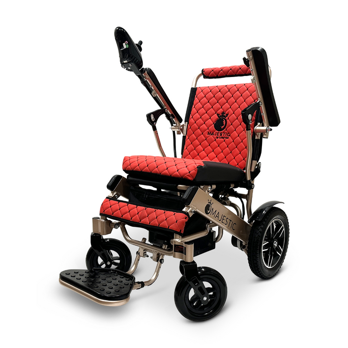 Introducing the ComfyGo MAJESTIC IQ-8000, a lightweight electric wheelchair designed for style and mobility. This travel-friendly model showcases red and black quilted upholstery with the Majestic logo, incorporating joystick control on the armrest, large rear wheels, and a foldable footrest for added convenience.