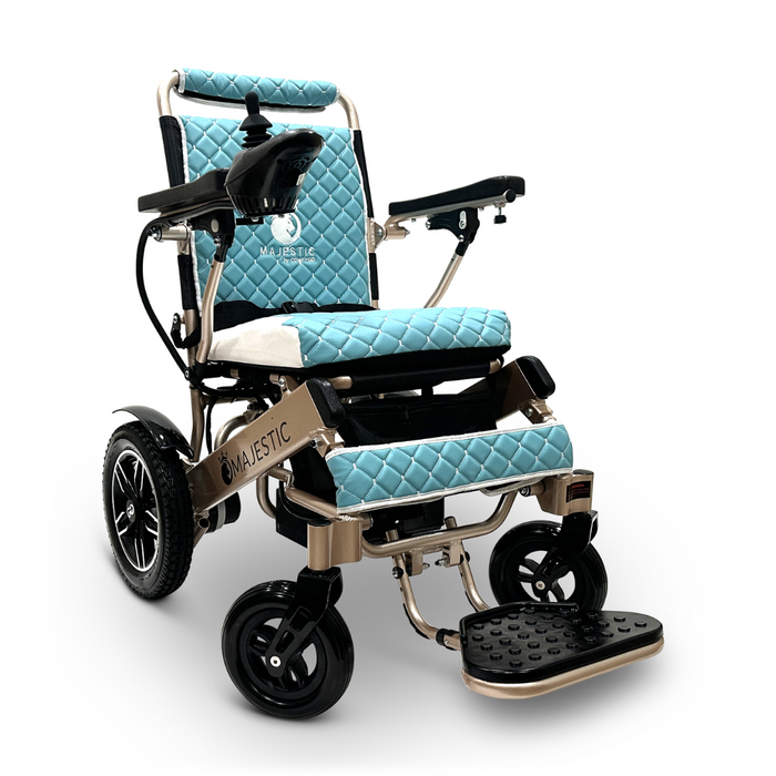 Introducing the ComfyGo MAJESTIC IQ-8000 Remote Controlled Lightweight Electric Wheelchair: This stylish, travel-friendly wheelchair features a quilted turquoise seat and backrest. Its lightweight metallic gold frame comes with joystick control conveniently placed on the armrest. The design includes four durable wheels and a textured footplate for enhanced comfort and style.