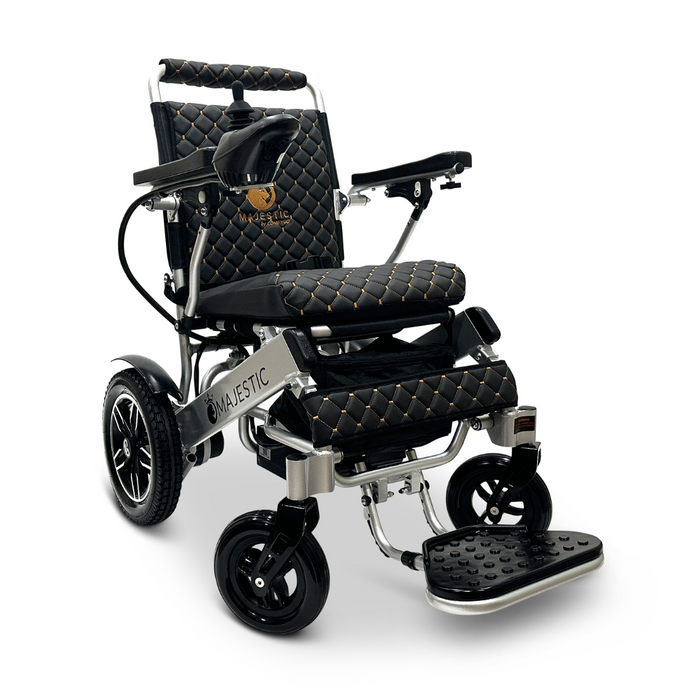 Introducing the ComfyGo MAJESTIC IQ-8000, a sleek and travel-friendly electric wheelchair with a black and gold design. Adorned with quilted upholstery and the word "Majestic" on the side, it features large rear wheels and a footrest for enhanced comfort. This lightweight wheelchair offers a stylish mobility solution for your journeys.