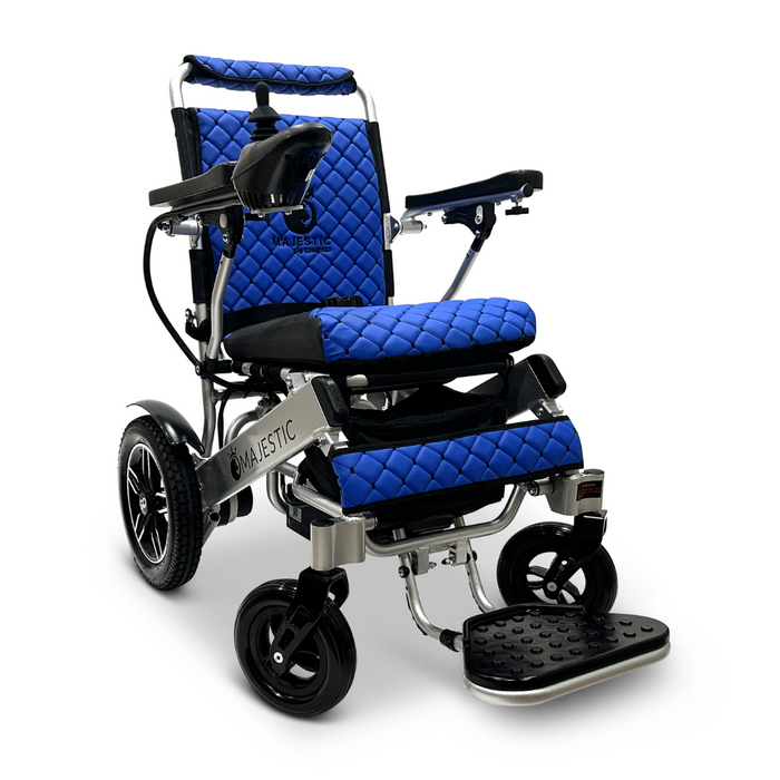 The ComfyGo MAJESTIC IQ-8000 Remote Controlled Lightweight Electric Wheelchair boasts a quilted seat and backrest, a foldable footrest, and joystick control on the armrest. Its metallic frame features large rear wheels and smaller front ones for easy travel. The MAJESTIC logo is prominently displayed on the seat.