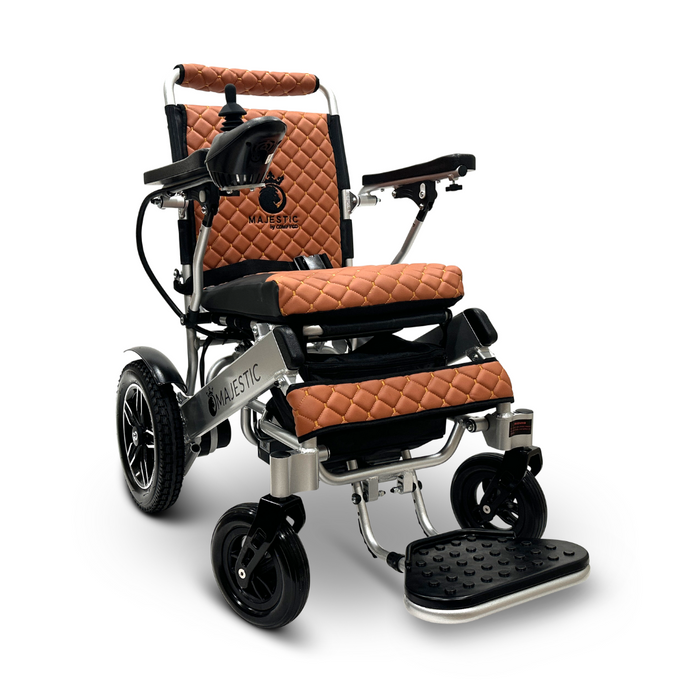 The ComfyGo MAJESTIC IQ-8000 Remote Controlled Lightweight Electric Wheelchair boasts a sleek design with brown quilted upholstery, black armrests, and a footrest. Its modern aesthetics include sturdy black wheels and a lightweight frame for travel-friendly convenience. The brand name Majestic is elegantly displayed on the backrest.