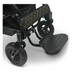 Detailed view of the sleek black ComfyGo MAJESTIC IQ-8000, a lightweight electric wheelchair equipped with durable rubber wheels and a textured footrest. This travel-friendly wheelchair is designed with a quilted handle cover enhanced by yellow stitching for added comfort and style.