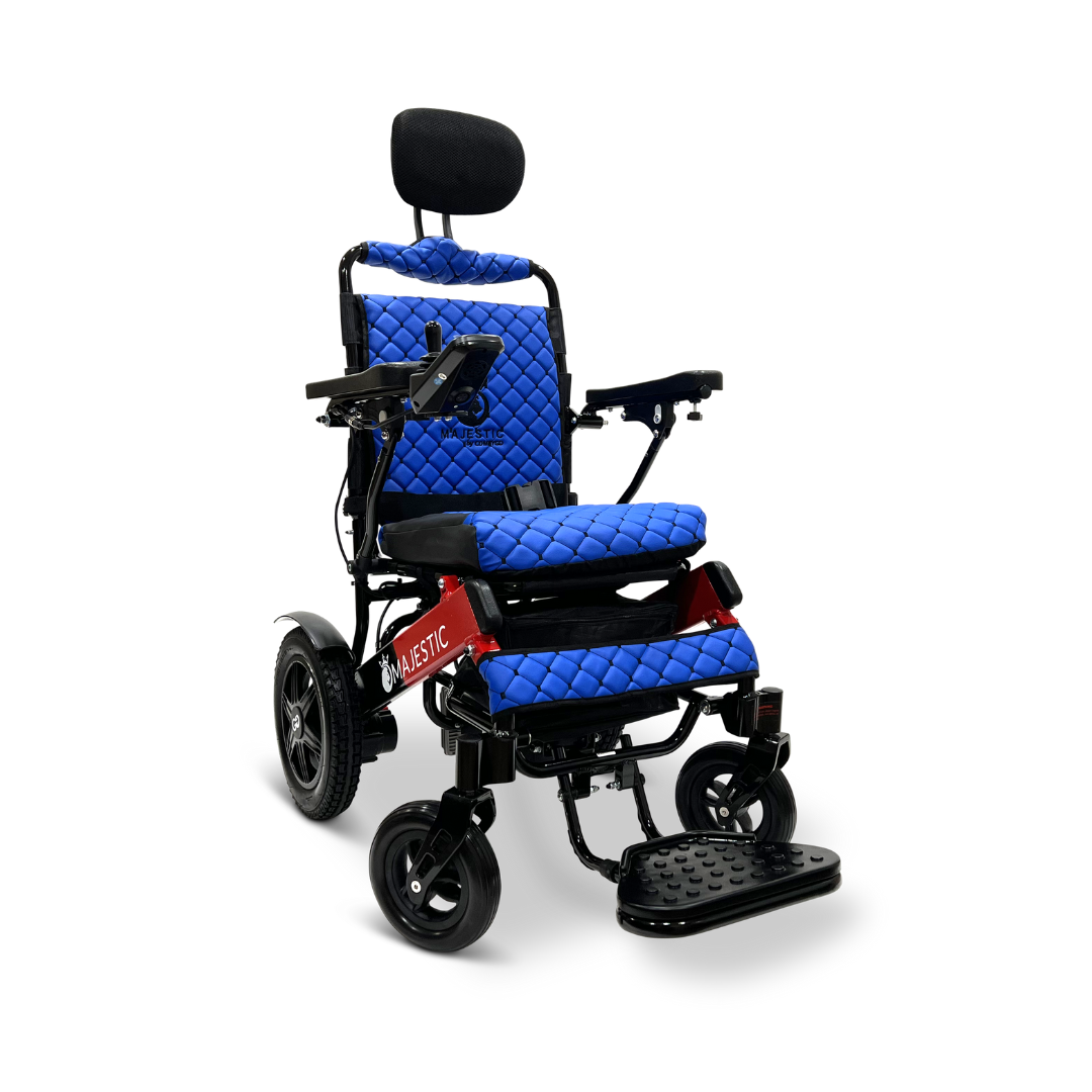 The ComfyGo MAJESTIC IQ-9000 Auto Recline Remote Controlled Electric Wheelchair features brushless silent motors, blue quilted cushions, and a stylish black headrest with armrests. It includes a red Majestic frame equipped with a digital joystick controller to enhance mobility and large rear wheels paired with smaller front ones for smooth travel.