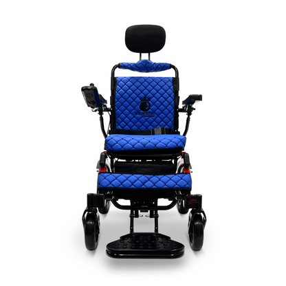 The ComfyGo MAJESTIC IQ-9000 Auto Recline Remote Controlled Electric Wheelchair is a blue quilted electric model with a sleek black frame, featuring a headrest, footrest, and arm control panel. It includes brushless silent motors and a digital joystick controller for improved mobility. Large rear wheels and smaller front wheels provide comfort, while the brand name MURAT is displayed on the backrest.