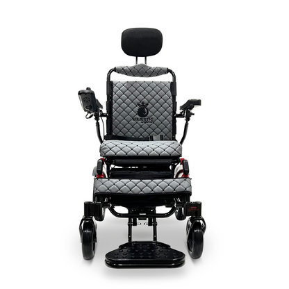 The ComfyGo MAJESTIC IQ-9000 Auto Recline Remote Controlled Electric Wheelchair features a sleek black frame and quilted gray cushions. It is equipped with a digital joystick controller and silent brushless motors, along with a headrest and footrest, seamlessly combining modern design with exceptional comfort and mobility.
