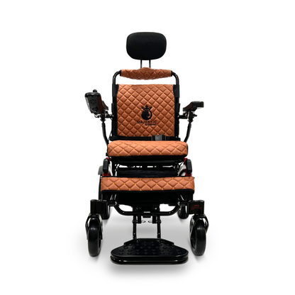 The ComfyGo MAJESTIC IQ-9000 Auto Recline Remote Controlled Electric Wheelchair in brown features a quilted leather design with a cushioned seat and backrest. It includes armrests equipped with a digital joystick controller on the right, footrests, and a headrest. Brushless silent motors ensure smooth and noiseless forward movement.