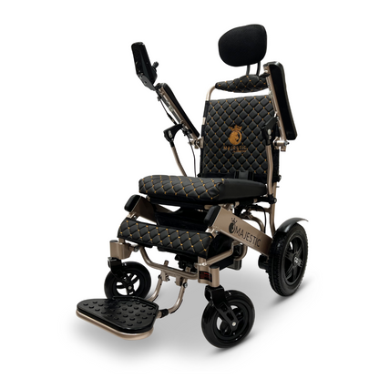 The ComfyGo MAJESTIC IQ-9000 Auto Recline Remote Controlled Electric Wheelchair exudes luxury with its black and gold quilted leather design. It features a padded headrest, adjustable armrests, and a foldable footrest for enhanced comfort and style, while the digital joystick controller and brushless silent motors offer a smooth ride.