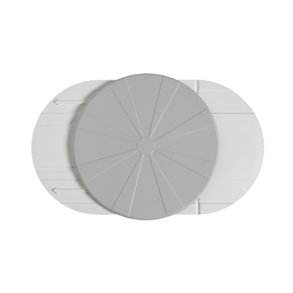 A top-down view of the Vitaturn Swivel and Transfer Aid, a light gray, circular device with segmented lines, positioned overlapping two elongated white oval components on a plain white background.