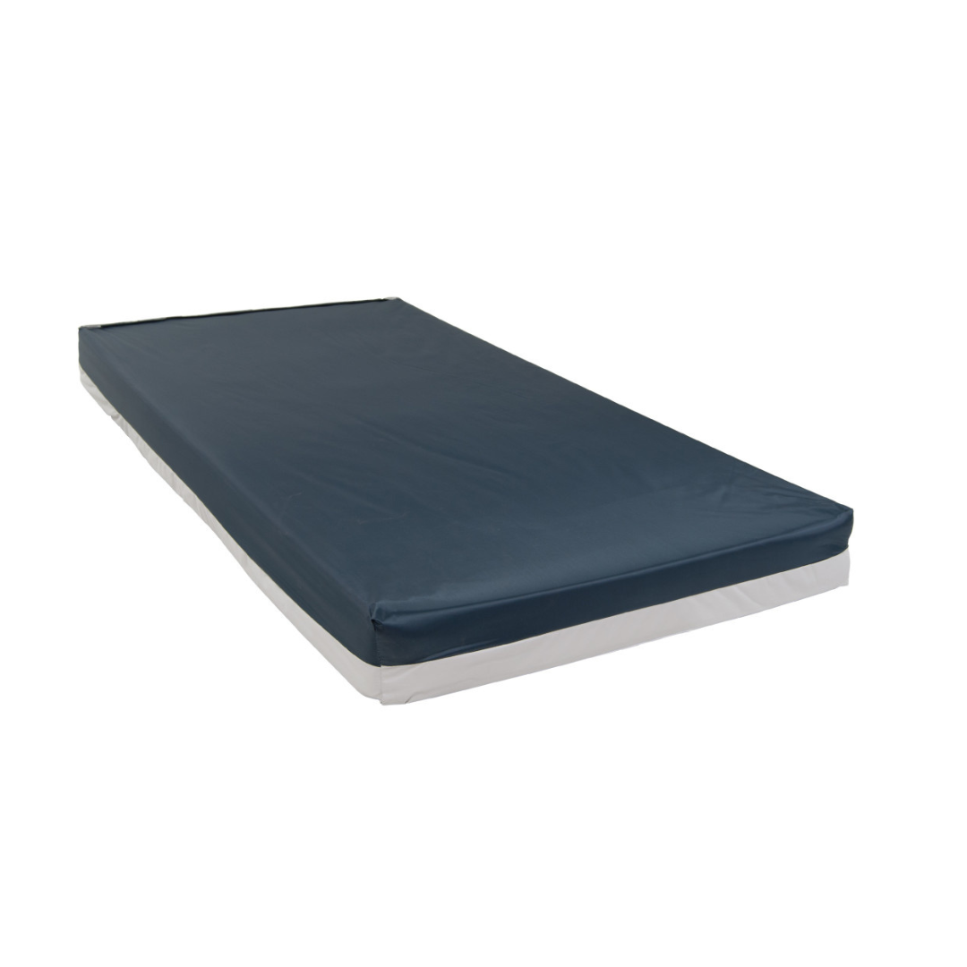 The Drive High-Density Bariatric Foam Mattress with Cover, featuring a dark blue top and white sides, is rectangular and made from high-density foam. It is shown on a plain white background.