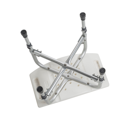 The Drive Deluxe Bariatric Shower Chair with Cross-Frame Brace is shown upside down, featuring sturdy adjustable metal legs and handles on each end for reliable support.