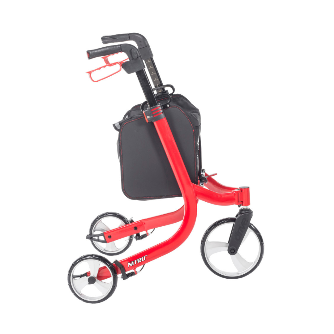 The Drive Nitro® 3-Wheel Rollator features a red, lightweight, foldable all-terrain Euro style design with large front and smaller rear wheels, a black storage bag, and cup holder—shown here in its compact folded position.