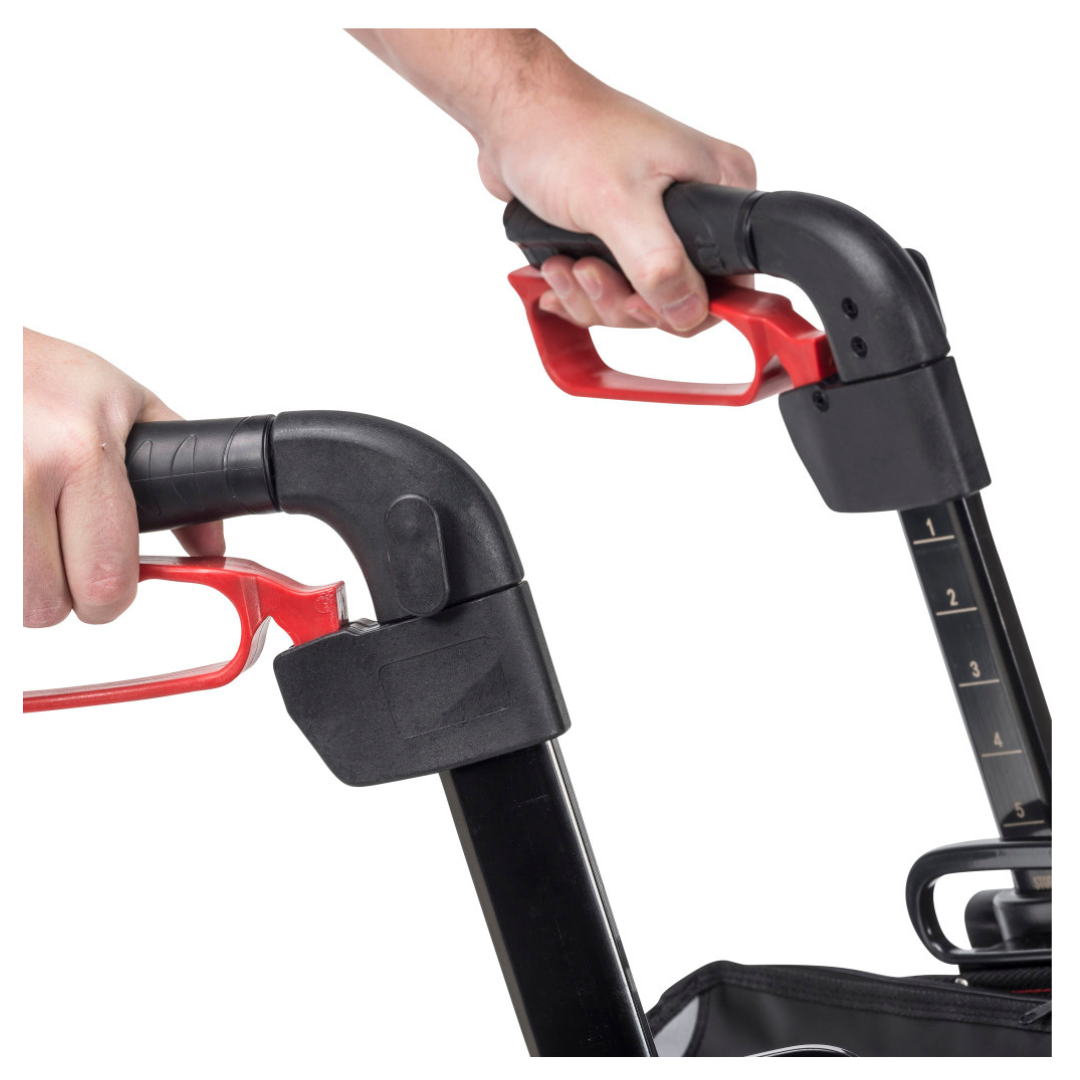Close-up of two hands gripping the black and red handles of the Drive Nitro® 3-Wheel Rollator, All-Terrain Euro Style Design, with one handle showing numbered height adjustment markings.