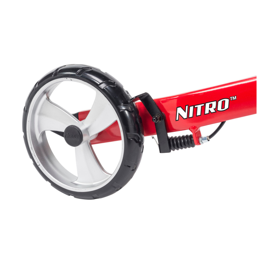 Close-up of the Drive Nitro® 3-Wheel Rollator's red metal frame, showing a large black and silver wheel with spring suspension and visible brake—key features of its all-terrain Euro style design.