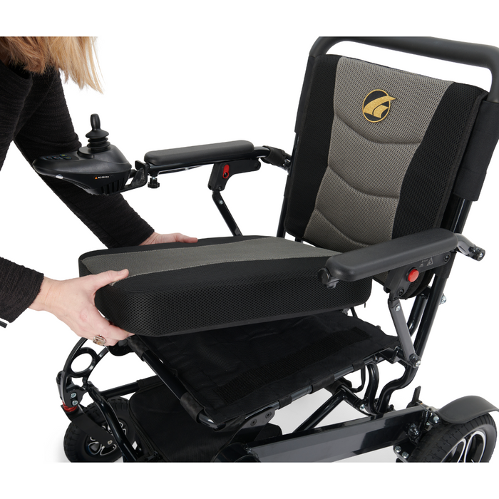 woman removing the seat on the Golden Tech Stride Folding Lightweight Powerchair
