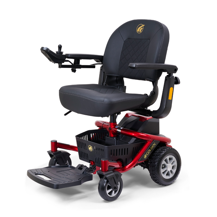 The Golden Tech LiteRider Envy Portable Power Chair is a compact red wheelchair with a black cushioned seat, armrests, joystick control, small wheels, and a footrest. It includes a convenient basket under the seat for portability.