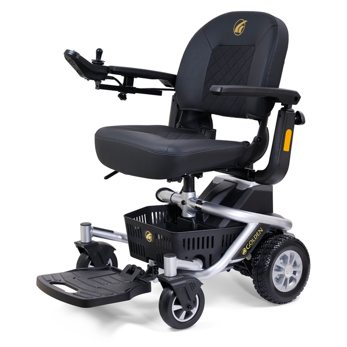 The Golden Tech LiteRider Envy Portable Power Chair is a sleek black and silver wheelchair with a cushioned seat, armrest joystick control, sturdy wheels, and an under-seat basket for storage.