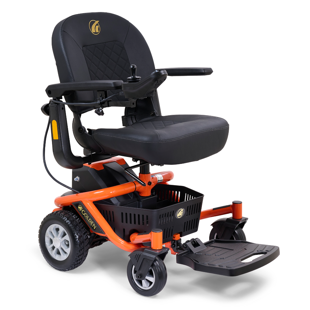 The Golden Tech GP162 LiteRider Envy Portable Power Chair offers a black cushioned seat, armrest joystick controls, sturdy wheels, footrest, orange frame, and underseat storage basket—ideal as a compact mobility aid.