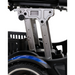 Close-up of the ultra-compact Golden Tech GP130 Buzzaround CarryOn Portable Powerchairs mechanical structure, highlighting metal joints and supports. A small basket is visible, while part of its folding wheel with a decorative blue stripe appears in the foreground.