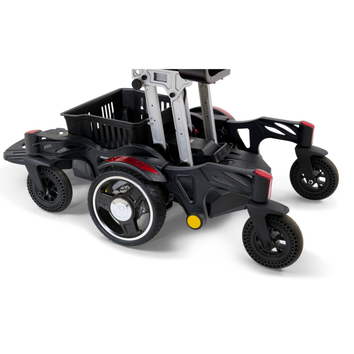 A close-up of the Golden Tech GP130 Buzzaround CarryOn Portable Powerchair, showcasing its black and red ultra-compact frame with a basket attachment, large sturdy wheels for outdoor use, and adjustable components for versatility akin to a folding power wheelchair.