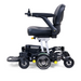 The Golden Tech GP130 Buzzaround CarryOn is a sleek, compact black power chair featuring high-tech electric functions. It offers cushioned seating, adjustable armrests, and 4-wheel suspension for smooth maneuverability. A joystick on the armrest ensures effortless control of this modern marvel.
