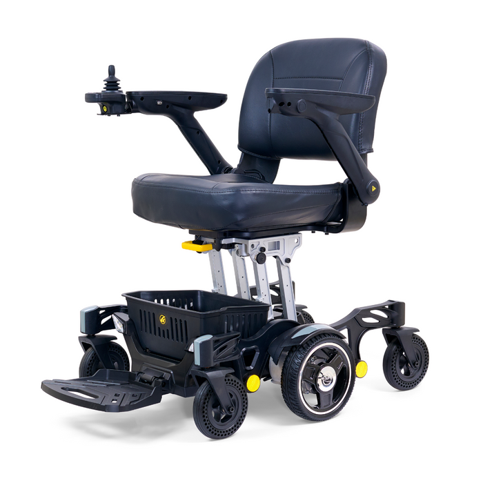 The Golden Tech GP130 Buzzaround CarryOn is an ultra-compact black electric wheelchair featuring a comfy cushioned seat with armrests, joystick control on one armrest, 4-wheel suspension for smooth rides, and a small basket underneath.