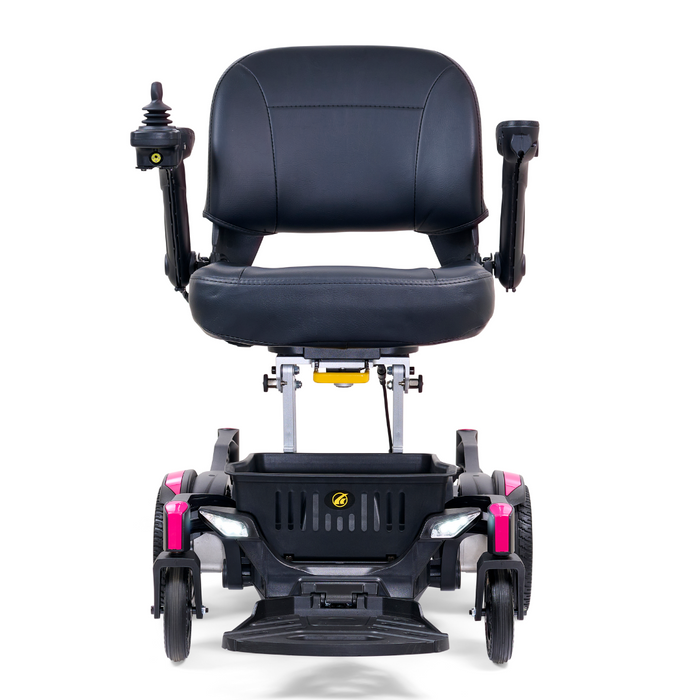 The Golden Tech GP130 Buzzaround CarryOn Portable Powerchair, shown in black with pink accents, features a padded seat, armrests, a right-armrest joystick control, and four stability-positioned wheels. Its ultra-compact design includes 4-wheel suspension for a smooth ride.