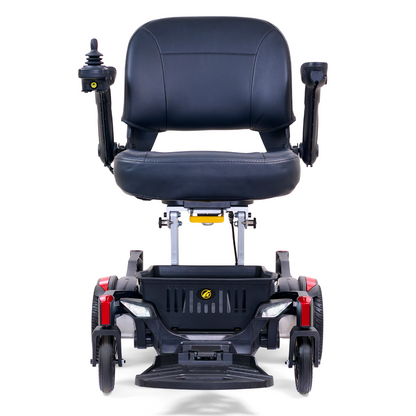 The Golden Tech GP130 Buzzaround CarryOn Portable Powerchair is an ultra-compact black mobility scooter with a cushioned seat, armrests, joystick control on the armrest, and four wheels with a 4-wheel suspension system. It also features red accents on the front.