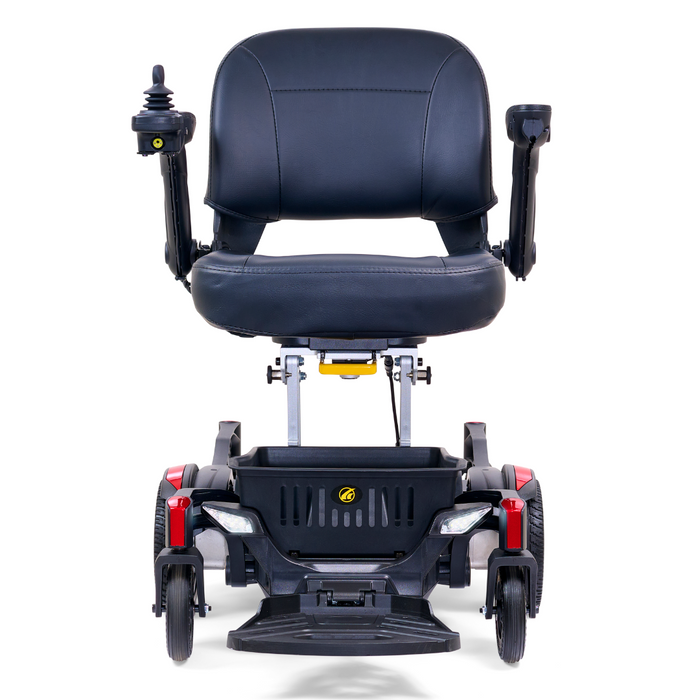 The Golden Tech GP130 Buzzaround CarryOn Portable Powerchair is an ultra-compact black mobility scooter with a cushioned seat, armrests, joystick control on the armrest, and four wheels with a 4-wheel suspension system. It also features red accents on the front.
