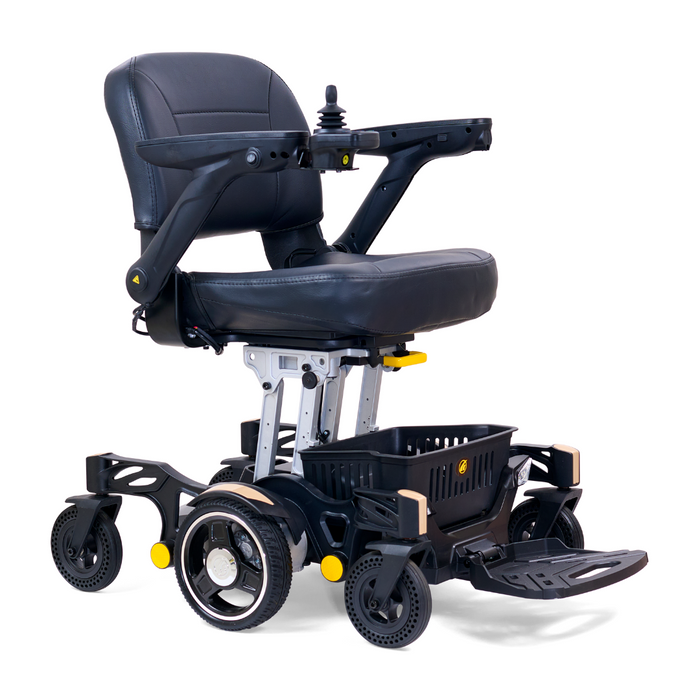 The Golden Tech GP130 Buzzaround CarryOn Powerchair is ultra-compact, black, and foldable. It features a cushioned seat, armrests, joystick control, four sturdy wheels with center wheel drive for easy maneuverability, a foldable footrest, and a storage basket beneath the seat.