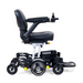 The Golden Tech GP130 Buzzaround CarryOn Portable Powerchair is an ultra-compact, folding powerchair with black leather seating, armrests, a right-hand joystick control, 4-wheel suspension, sturdy metal frame, large wheels, and a foldable footrest for enhanced mobility and comfort.