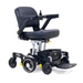 The Golden Tech GP130 Buzzaround CarryOn Portable Powerchair boasts a modern ultra-compact design with a black seat, armrests, and right-hand joystick control. This sleek folding power wheelchair includes four wheels, an under-seat basket, and a footrest for optimal functionality.