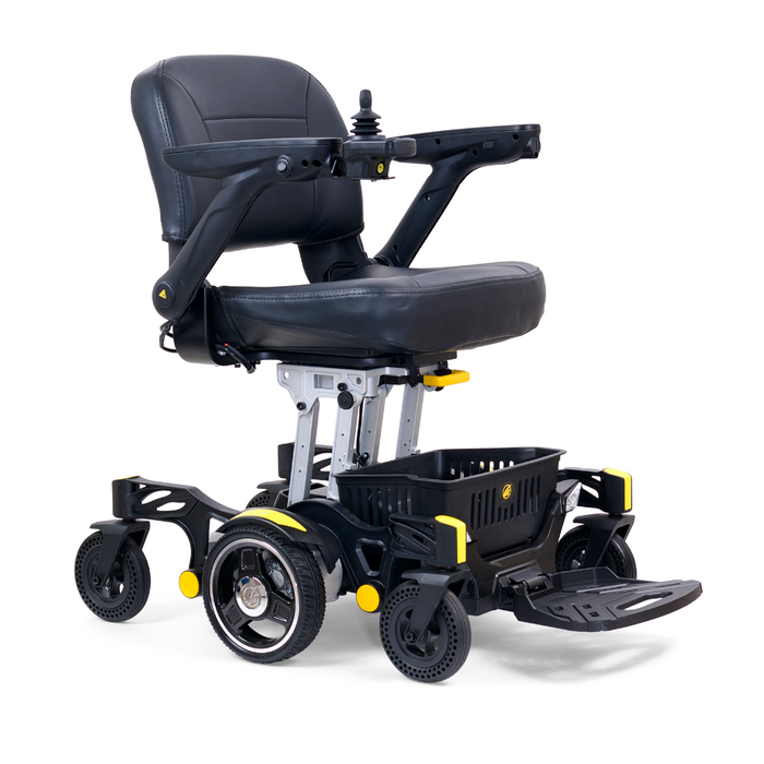 The Golden Tech GP130 Buzzaround CarryOn is an ultra-compact, black and silver electric wheelchair featuring armrests, a right-side joystick controller, a footrest, 4-wheel suspension for smooth rides, an under-seat basket, and stylish black wheels with yellow accents.