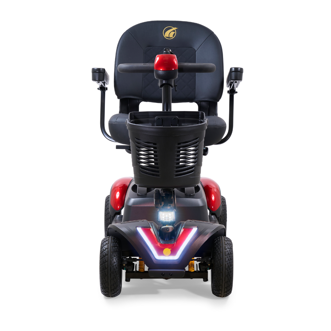 Front view of a Golden Tech GB148 Buzzaround EX Portable Mobility Scooter in red and black with LED lights, four wheels, padded seat with armrests, steering handlebar, and modern design; travels up to 18 miles per charge.