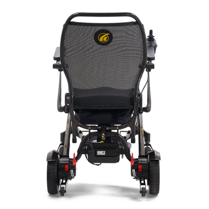 Rear view of the Golden Tech Carbon Fiber Cricket Power Wheelchair (only 33 lbs) with mesh backrest, right arm joystick, large rear wheels, and a yellow circular logo on the lightweight frame.