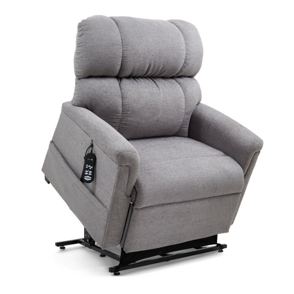 The Golden PR535 MaxiComfort Recliner w/ Lift Assist in medium has a plush backrest and armrests, displayed upright on a raised black base for ergonomic support. A remote with various buttons is attached to the left arm of this gray chair as part of the Comforter Series.