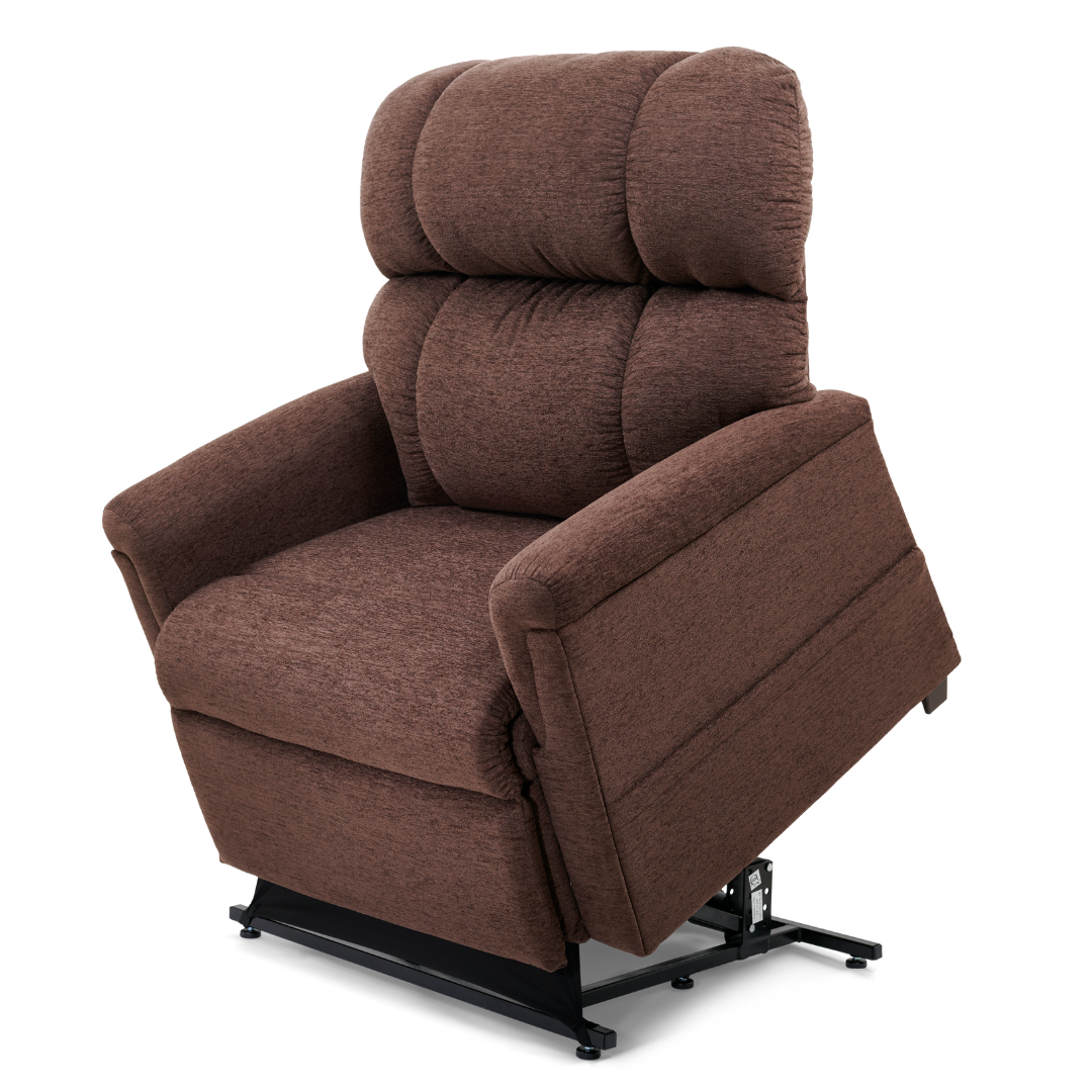 The Golden PR535 MaxiComfort Recliner w/ Lift Assist - Medium is shown in brown from a three-quarter angle. It features soft, ergonomic cushioning and is slightly tilted forward to showcase its MaxiComfort Positioning, with a sturdy base crafted from a robust metal frame.
