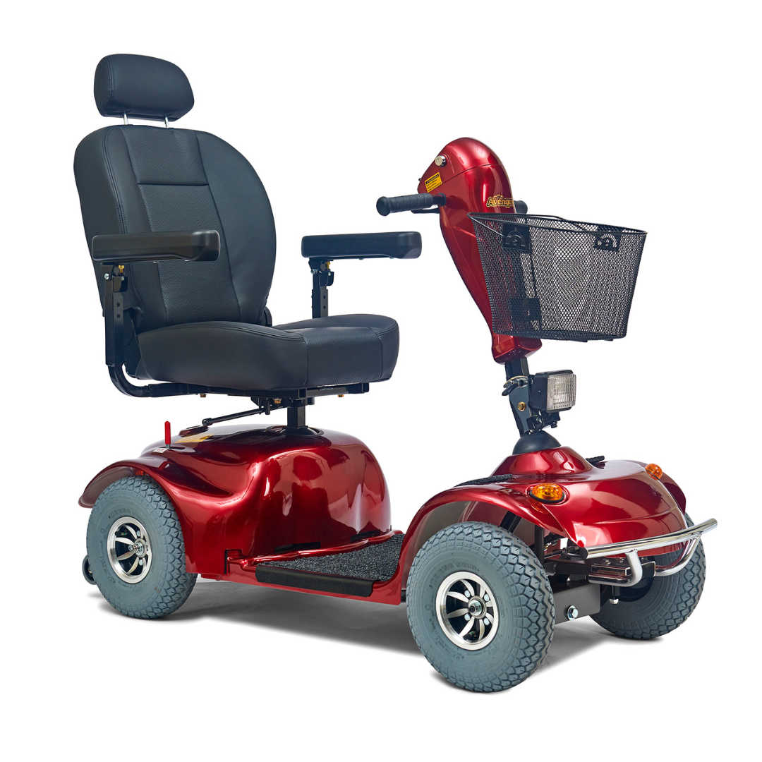 The Golden Tech Avenger HD Bariatric Mobility Scooter is a heavy-duty red scooter with a black seat and armrests. It has four large wheels for rugged terrain, a front-mounted basket, headlight, sleek design, long operating range, and handlebar-mounted control panel.