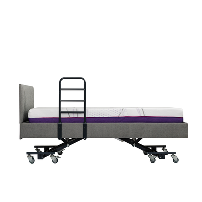 A side view of an adjustable hospital-style bed with a grey upholstered frame, mattress, iCare Medical Bed Safety Rails for support and fall prevention, plus wheels on the legs, isolated on a white background.
