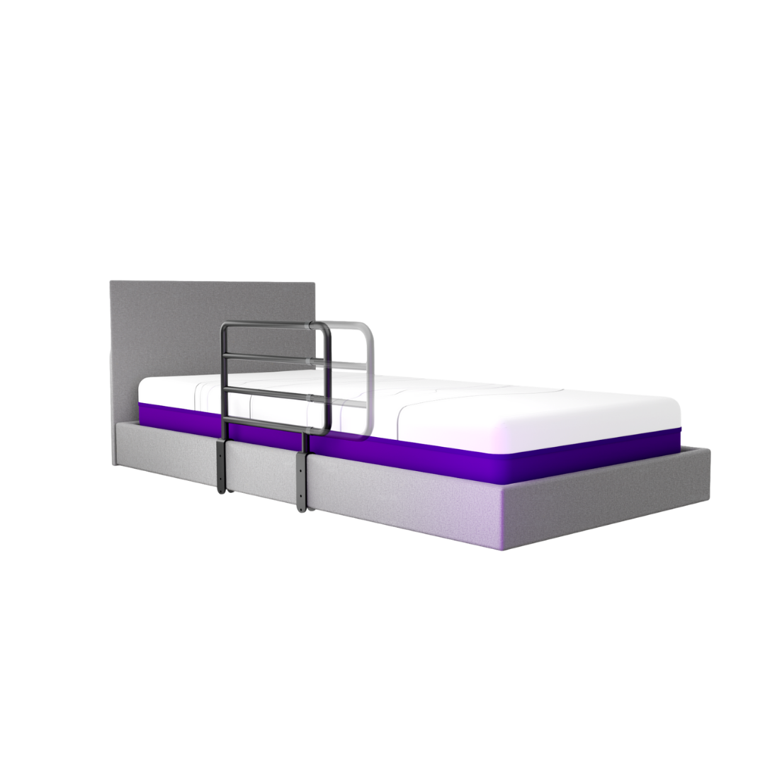 A grey bed with a headboard and a mattress with a white top and purple middle layer features iCare Medical Bed Safety Rails attached to the side for reliable support and enhanced fall prevention.