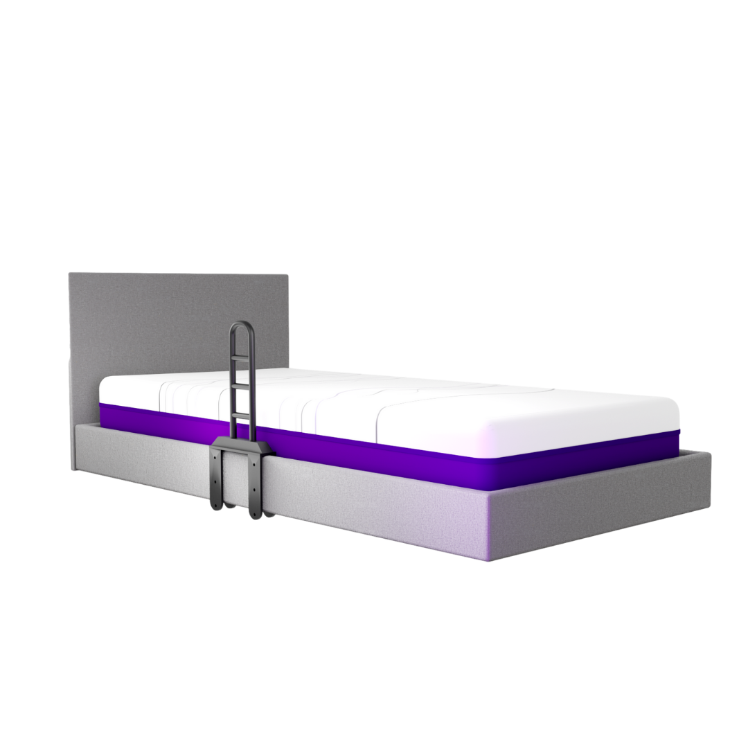 A modern gray bed with a large headboard features an iCare Medical Bed Safety Rail for bedside support and fall prevention. It includes a white and purple mattress, plus a small attached safety ladder. The bed is set against a plain white background.