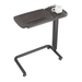 The iCare Medical Over Bed Tilting Table features a dark wood surface with a raised edge, metal frame, height adjustment, four wheels for easy movement, and a multi-purpose design—ideal for any room. A white mug sits in one corner.