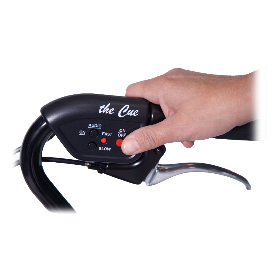 A hand grips the handlebar of a Nero Walker fitted with the In-Step Mobility Laser & Sound Cueing Module, which features a control panel for audio, speed (slow/fast), and power, plus a red button—an aid for Parkinson’s freezing with sound cueing.