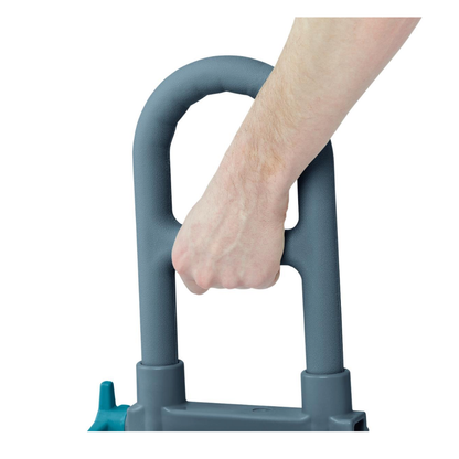 A close-up of a persons hand gripping the non-slip, light gray handle of the Medline Deluxe Bathtub Grab Bar with Microban antimicrobial protection against a white background.