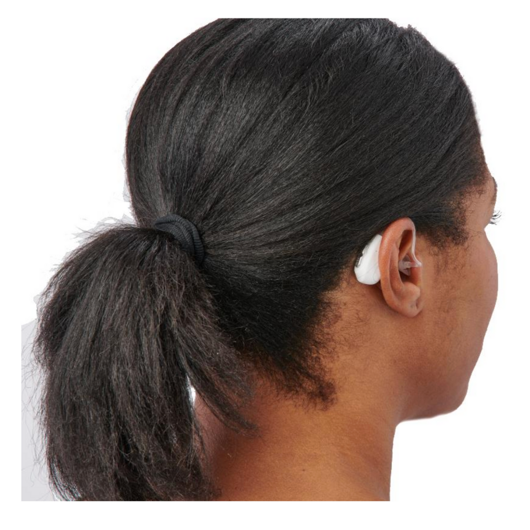 A person with dark hair in a ponytail wears the Medline Rechargeable Digital OTC Hearing Aid in behind-the-ear style with noise reduction on their right ear, viewed from the back and side.