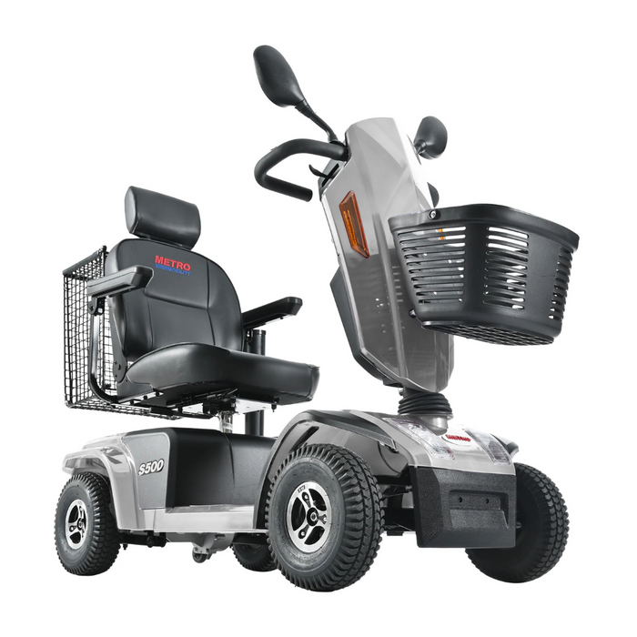 The Metro Mobility S500 Heavy Duty 4-Wheel Power Scooter in gray features a cushioned seat, backrest, armrests, front basket, side mirrors, and prominently displays model S-600 on the front.
