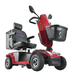 The red Metro Mobility S500 heavy-duty 4-wheel power scooter features a cushioned seat, backrest, handlebars with a rearview mirror, front basket, and sturdy wheels, ensuring style and reliability for every journey.
