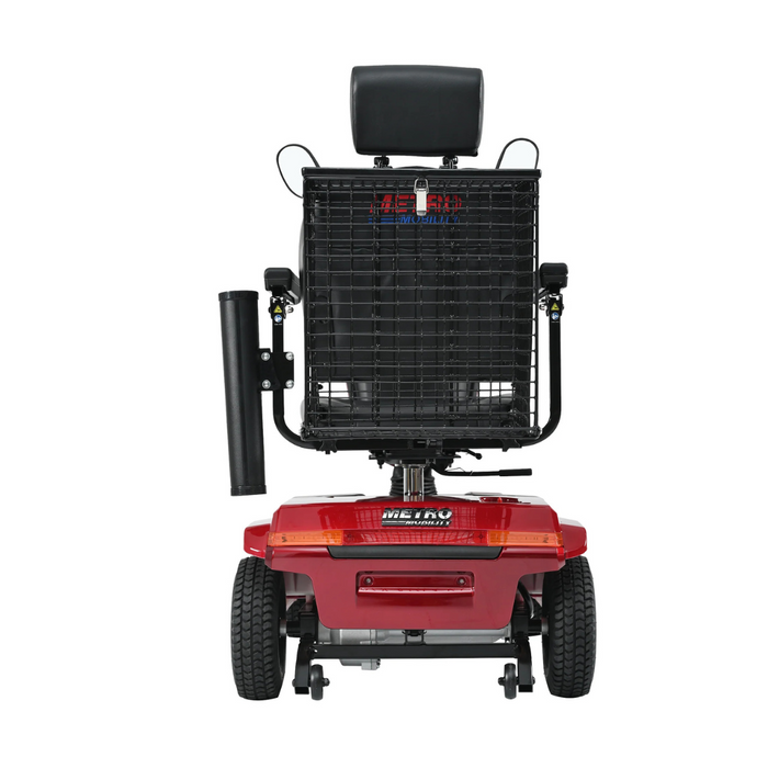 The Metro Mobility S500 Heavy Duty 4-Wheel Power Scooter is shown from the rear, highlighting its vibrant red color with a black seat and headrest. It features two rear wheels and a basket in the back, all set against a white background.