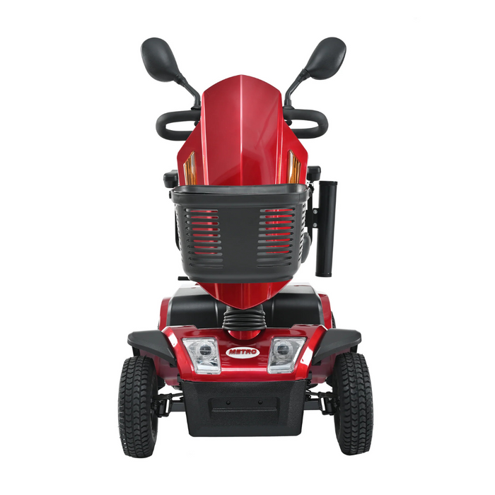 Front view of the Metro Mobility S500 Heavy Duty 4-Wheel Power Scooter, showcasing its red color with black accents. Equipped with two small headlights and side mirrors, this scooter offers stability and features the Metro brand name on the lower front panel.