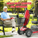 An elderly person sits on a park bench, smiling with a book in hand. Next to them is the Metro Mobility S500 Heavy Duty 4-Wheel Power Scooter. The text reads Heavy-Duty Scooter for Social Independence, set against a backdrop of trees and grass.
